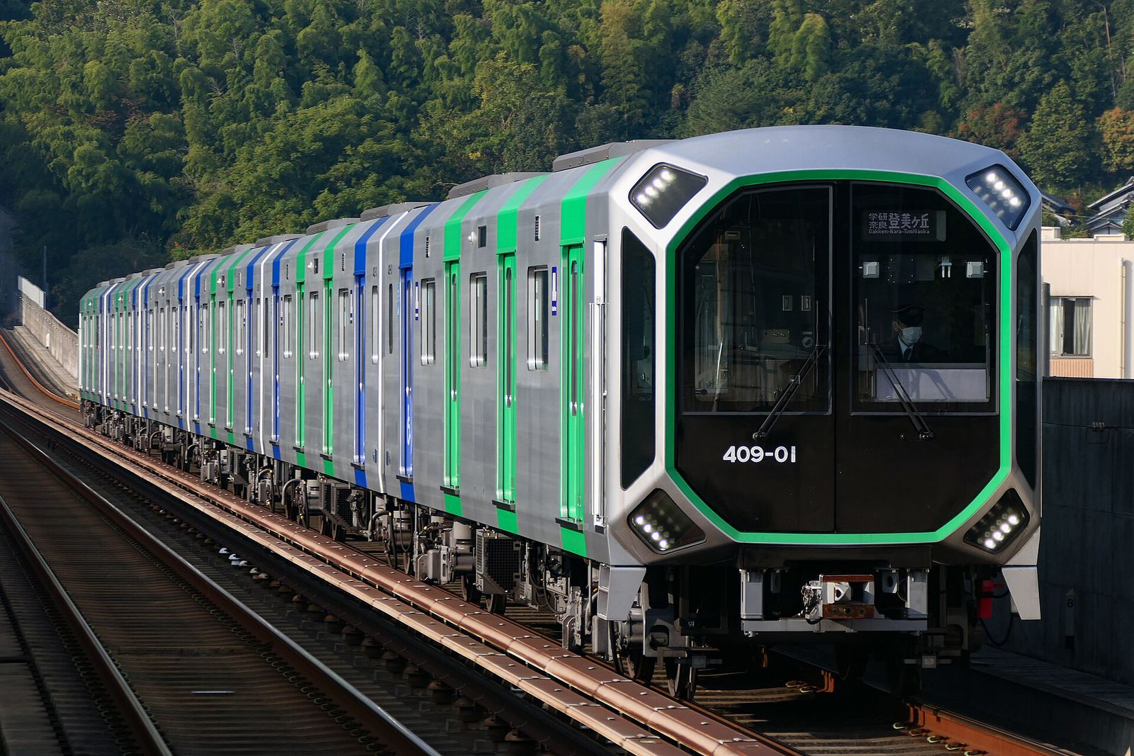 An Osaka Metro train arriving at a station platform